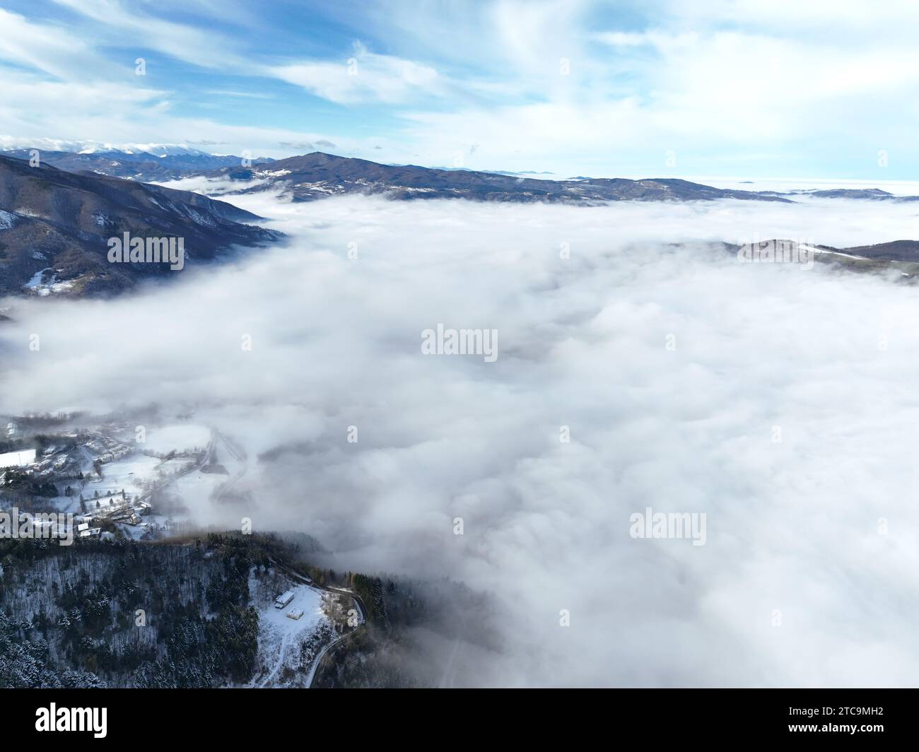 Majestic mountain range blanketed in freshly fallen snow with a sky ...