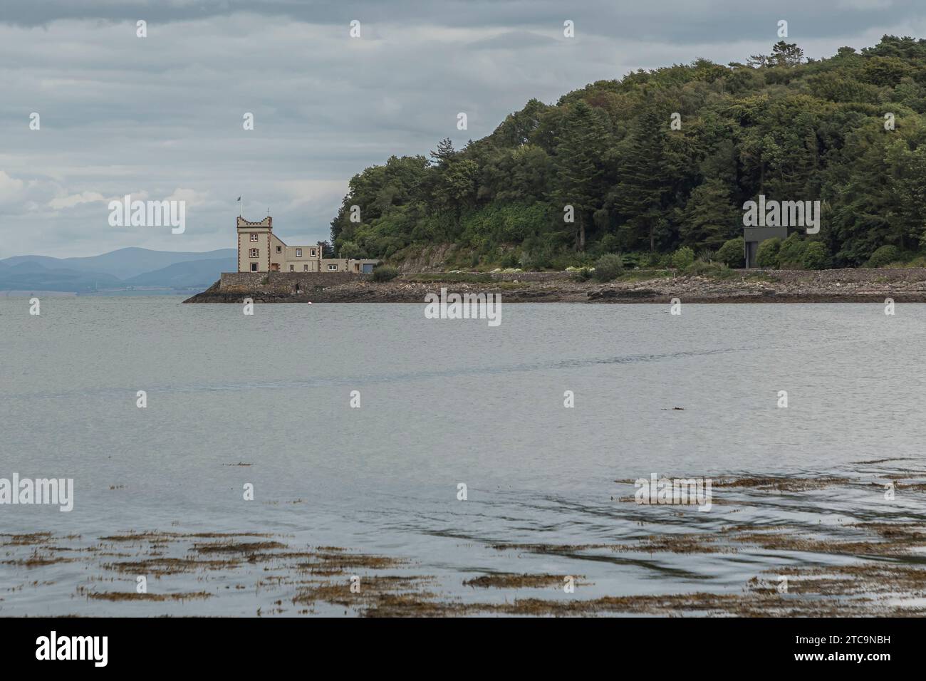 Scotland, United Kingdom - July 24th 2023 - Castle type building on the edge of the sea with the tide in Stock Photo