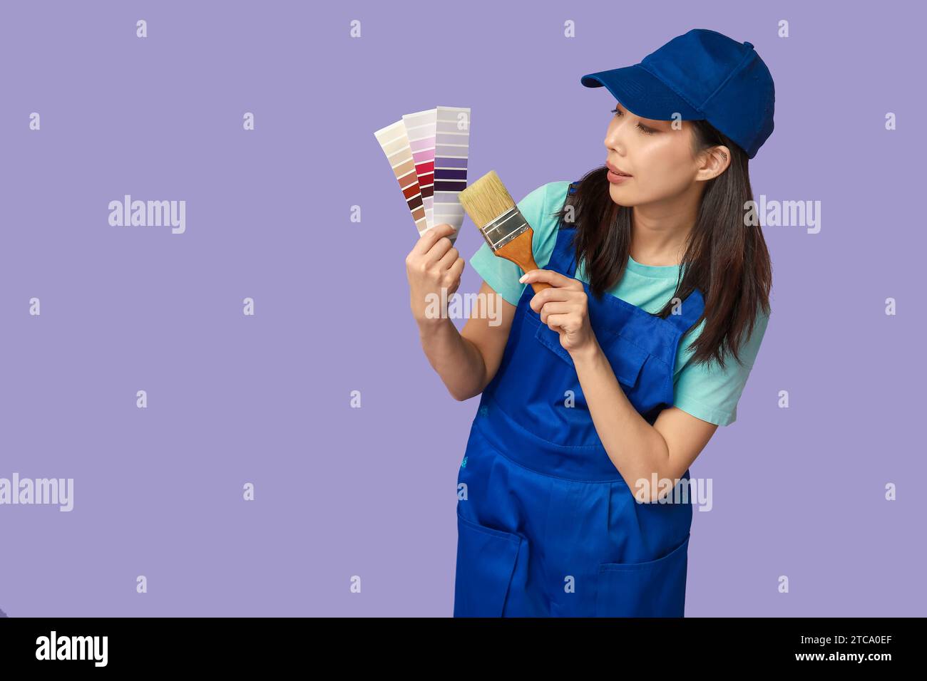 Female Asian painter with brush and paint color palettes on purple ...
