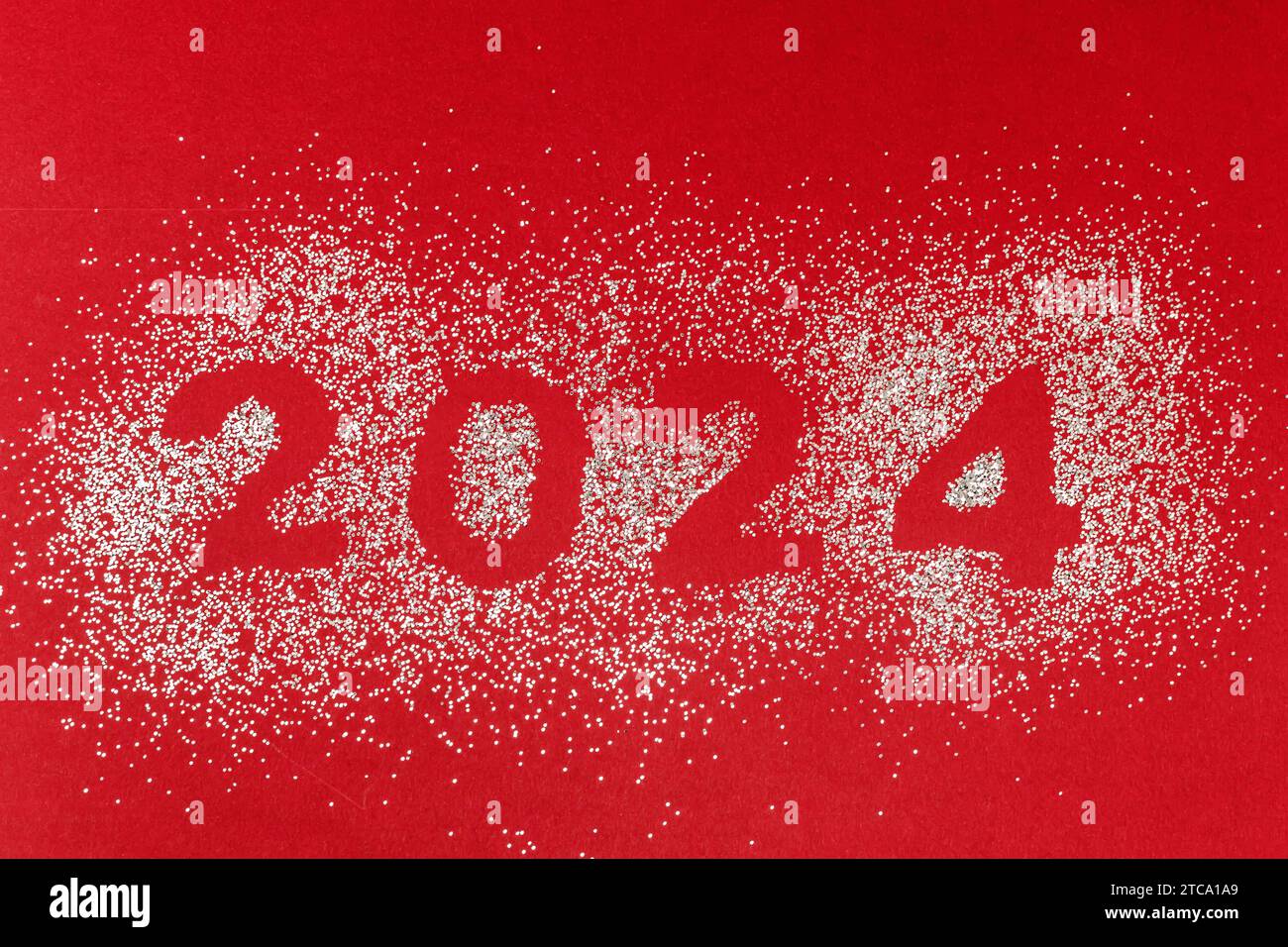 Silver Shiny Glitter With Shape Of 2024 Numbers On Red New Year S   Silver Shiny Glitter With Shape Of 2024 Numbers On Red New Years Concept 2TCA1A9 