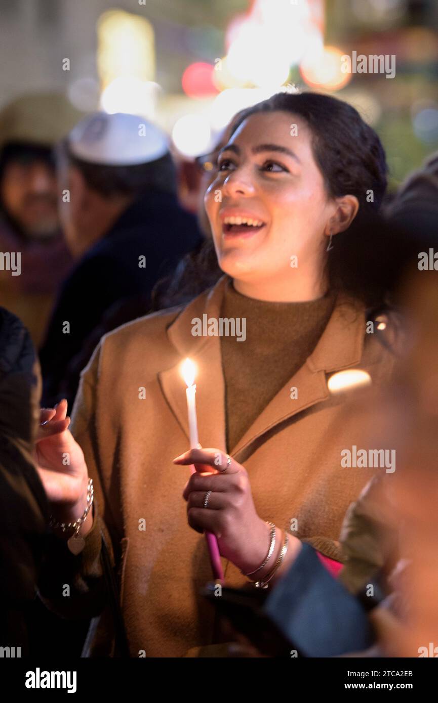Rome, Italy. 10th Dec, 2023. People sing traditional songs and hold lit