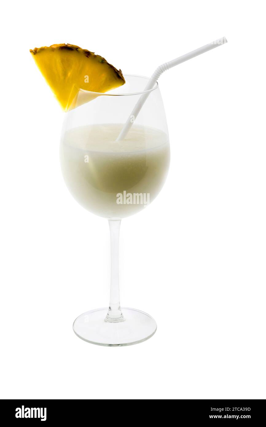 Pina Colada mixed drink with umbrella garnish on white background Stock Photo
