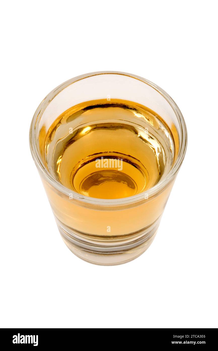Whiskey neat in shot glass on white background Stock Photo