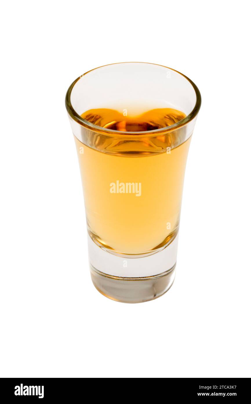 Whiskey neat in shot glass on white background Stock Photo