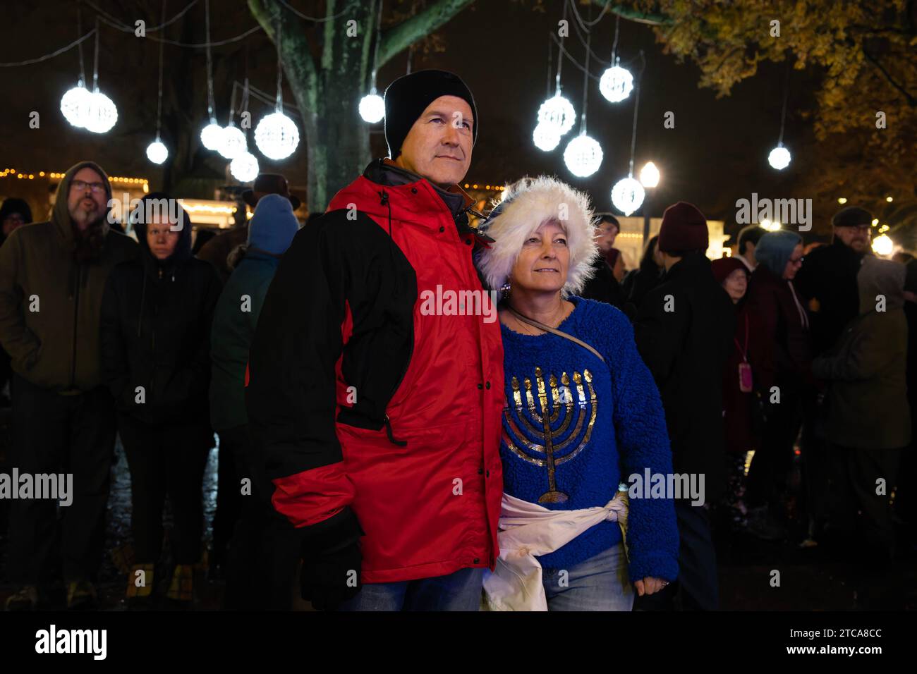 Marietta, GA, USA. 10th Dec, 2023. Ben and Louise Probst of Smyrna watch as the fourth candle is lit on a large menorah at Glover Park Sunday, celebrating the fourth night of Hanukkah. (Credit Image: © Robin Rayne/ZUMA Press Wire) EDITORIAL USAGE ONLY! Not for Commercial USAGE! Stock Photo