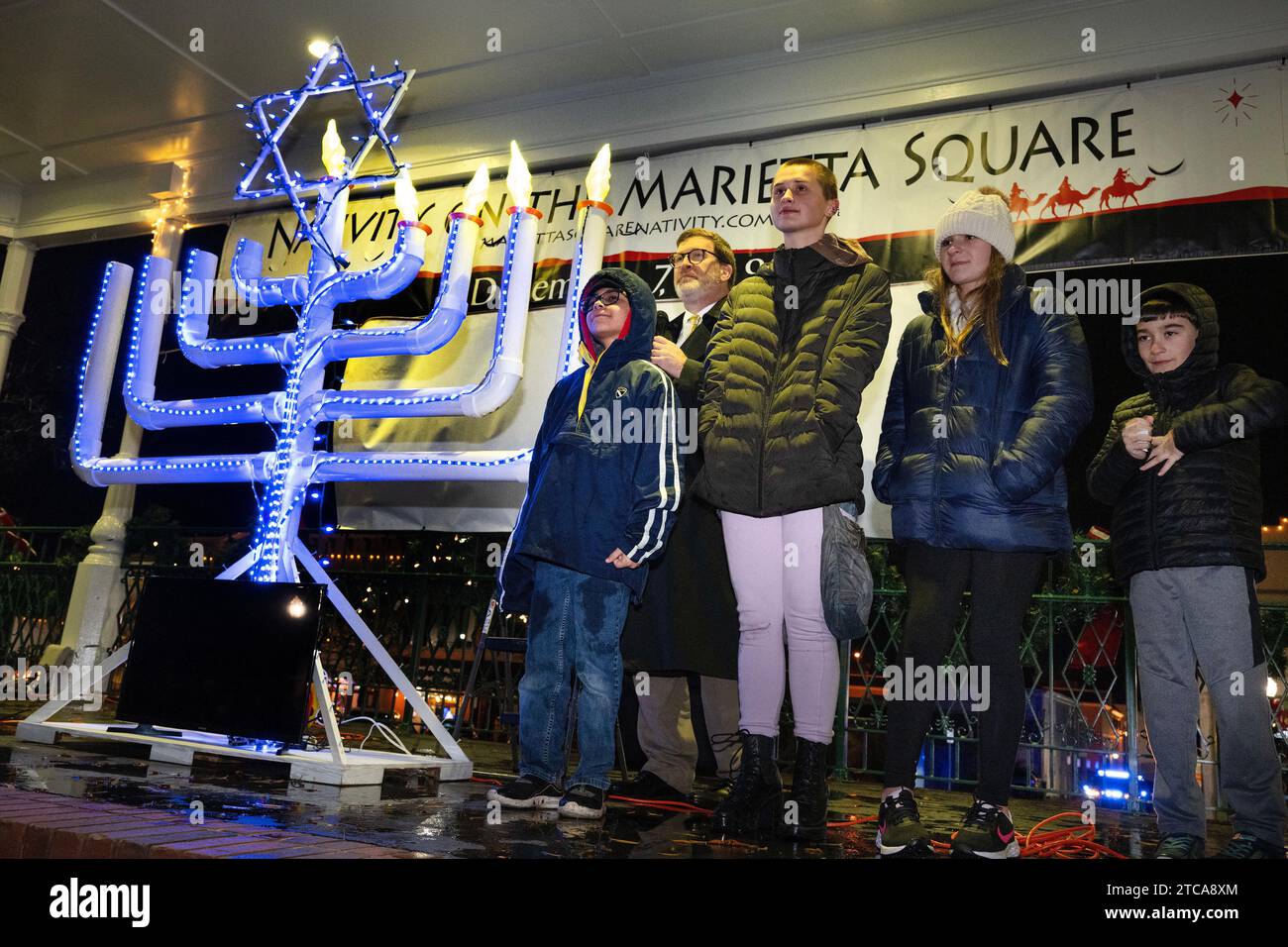 Marietta, GA, USA. 10th Dec, 2023. Rabbi Joseph Prass is joined by area students as they lead crowd at Glover Park in the blessing for lighting the menorah on the fourth night of Hanukkah. (Credit Image: © Robin Rayne/ZUMA Press Wire) EDITORIAL USAGE ONLY! Not for Commercial USAGE! Stock Photo