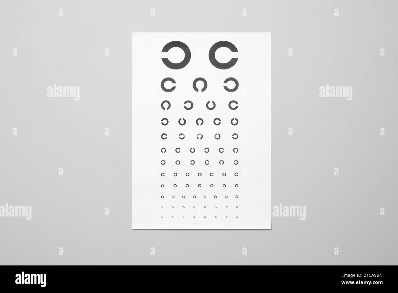 Vision test chart on gray background. Ophthalmic exam Stock Photo