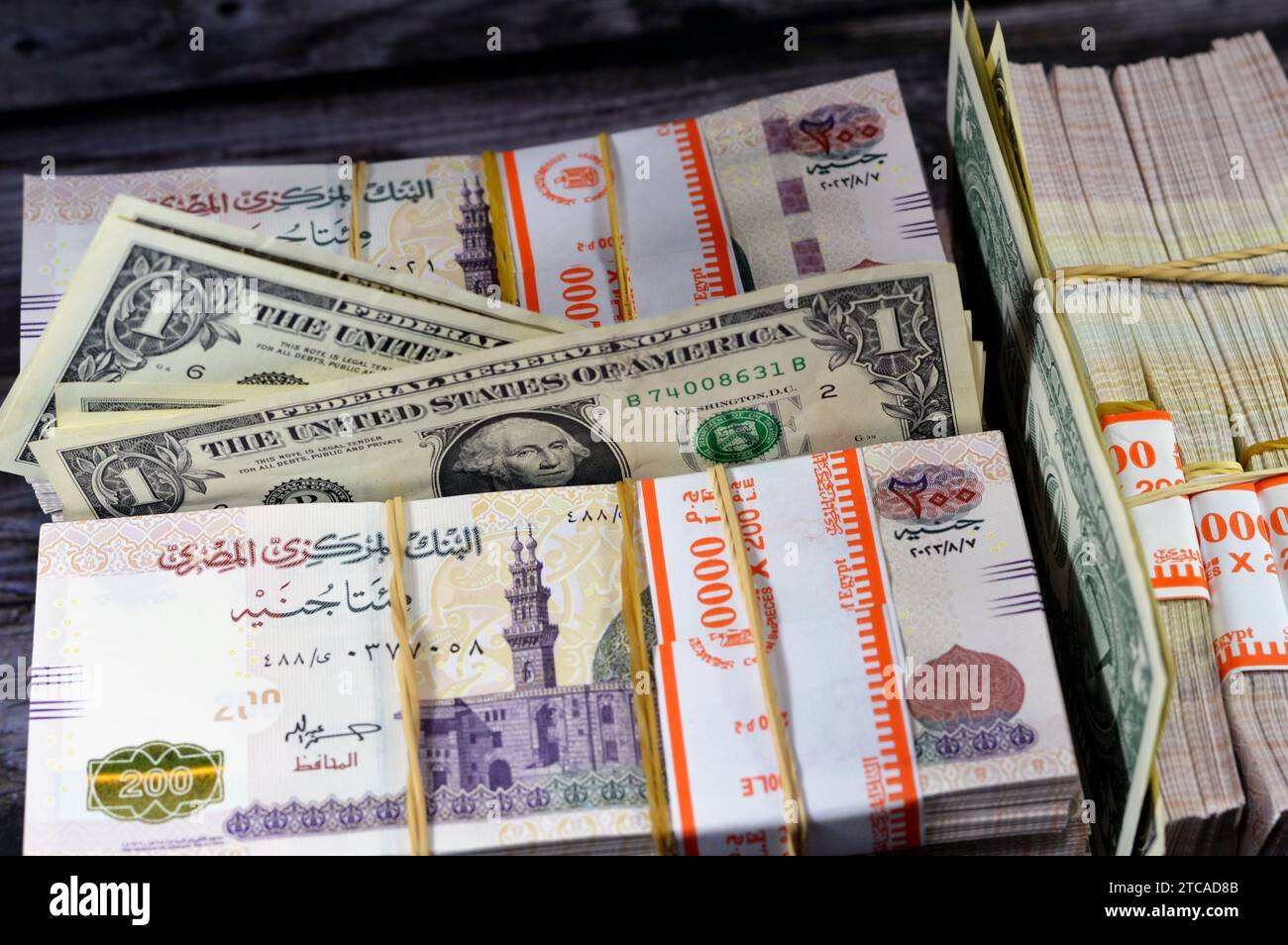 piles-and-stacks-of-egypt-money-thousands-of-pounds-currency-banknotes-bills-of-200-egp-le-egyptian-money-exchange-rate-and-usa-american-dollars-ban-2TCAD8B.jpg