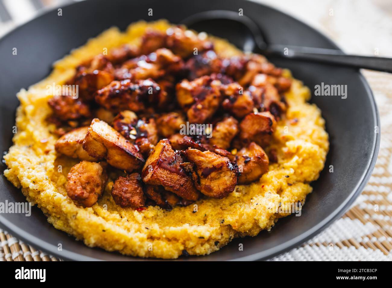 plantbased polenta with teriyaki tofu chunks, healthy vegan food recipes Stock Photo Alamy