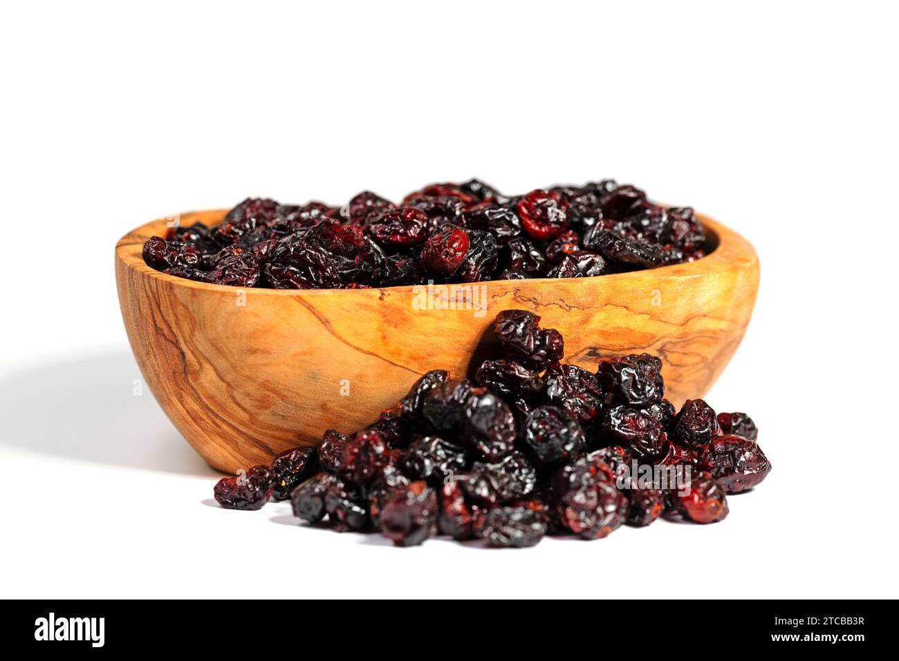 Dried cranberries in a wooden bowl Stock Photo