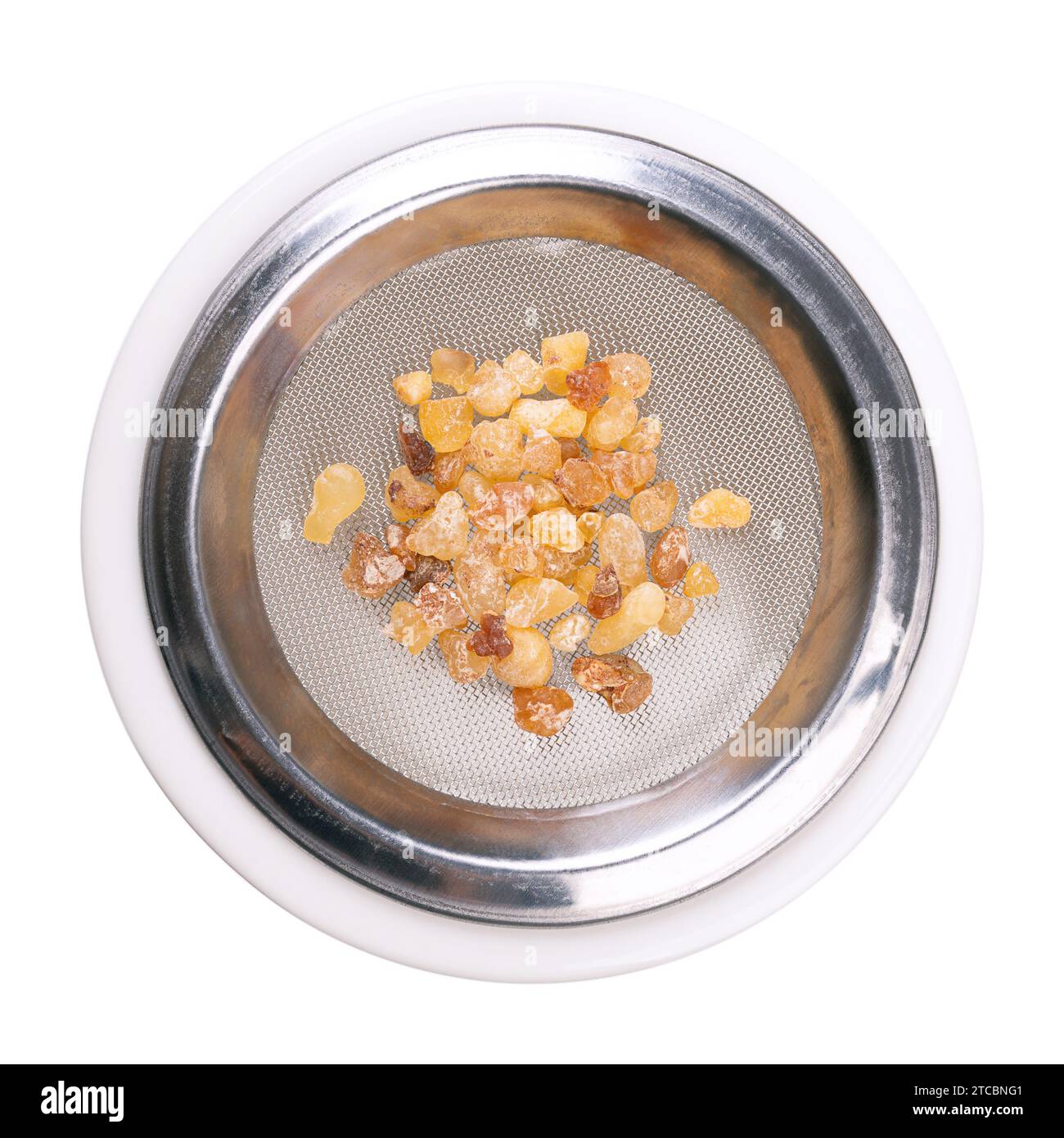 Frankincense on the sieve of an incense burner, from above. Tears or pieces of hardened olibanum resin. Aromatic resin, used in incense and perfumes. Stock Photo