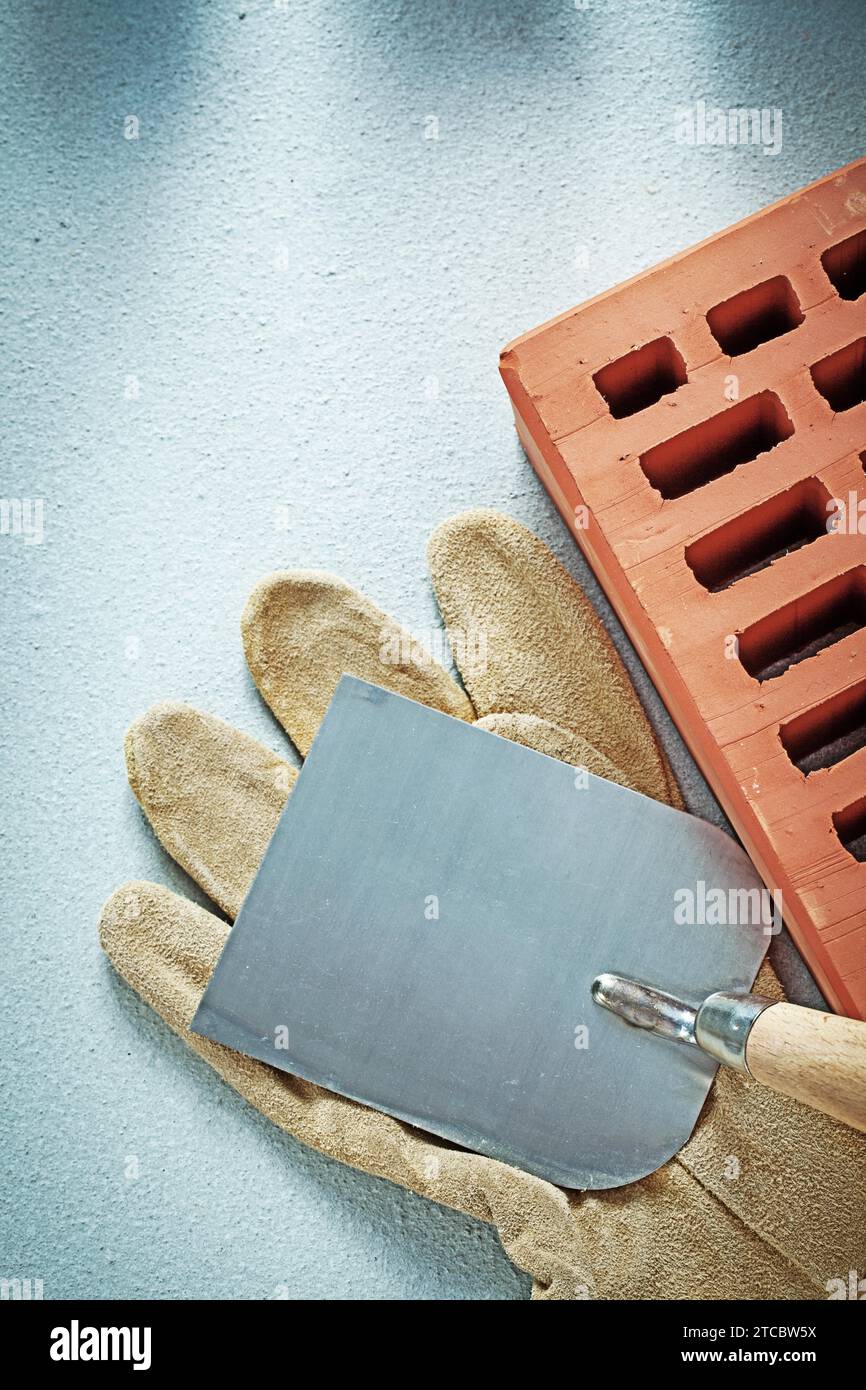 Construction brick safety gloves plastering trowel on concrete surface bricklaying concept Stock Photo