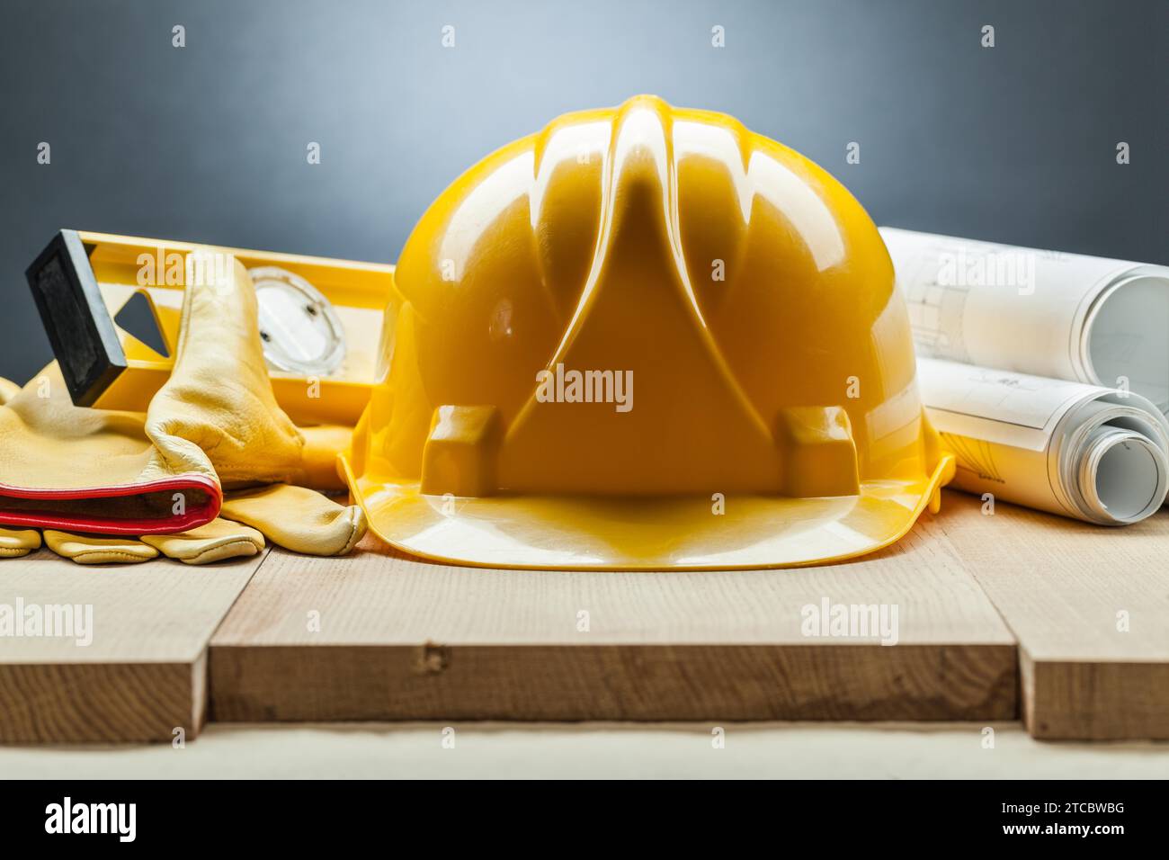 Construction level Helmet Gloves Blueprints Stock Photo