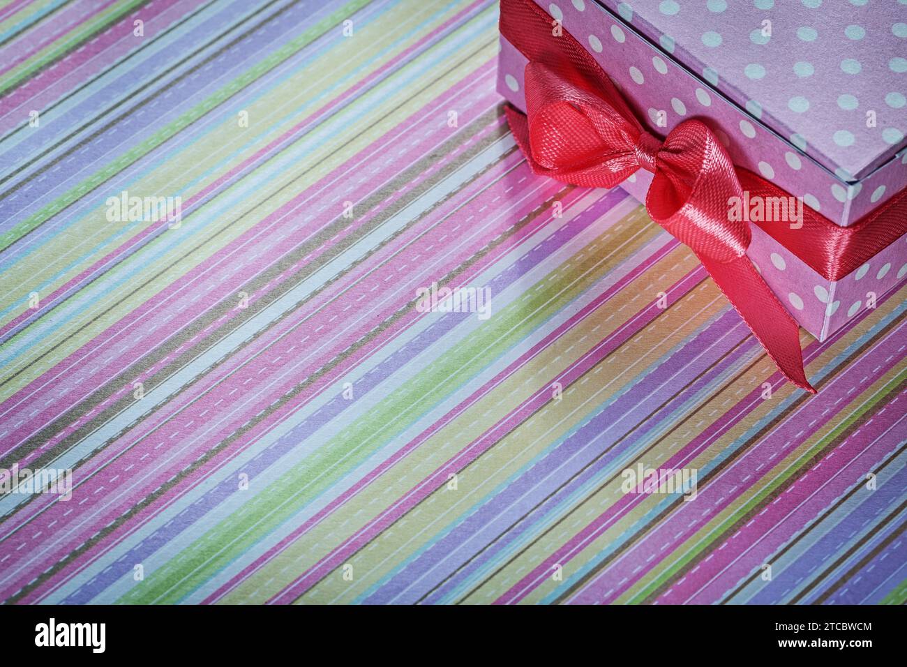 Decorated gift box on striped tablecloth holiday concept Stock Photo