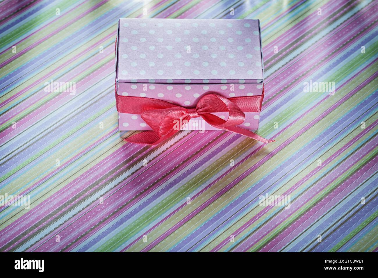 Decorated gift box on striped tablecloth Celebration concept Stock Photo
