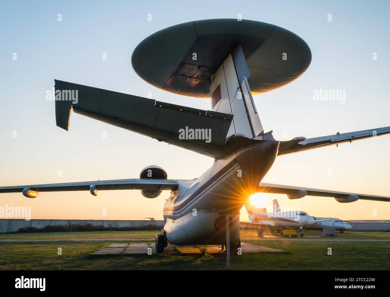 Old soviet reconnaissance aircraft at the airport with the rays of the evening sun Stock Photo