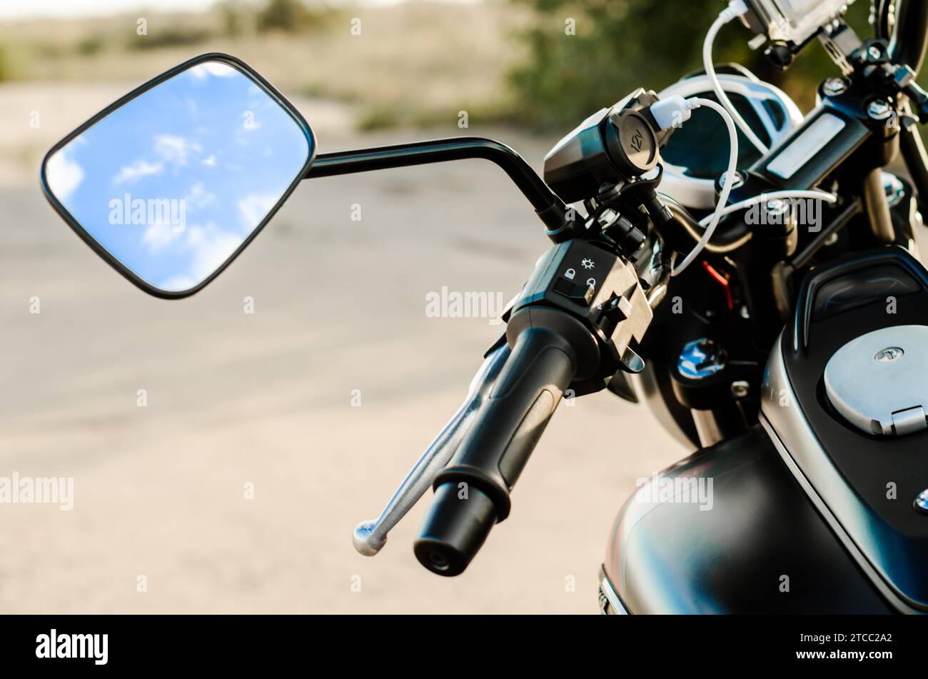 Reflection of the nab and clouds in the motorcycle mirror, motorcycle steering wheel and motorcycle fuel tank Stock Photo