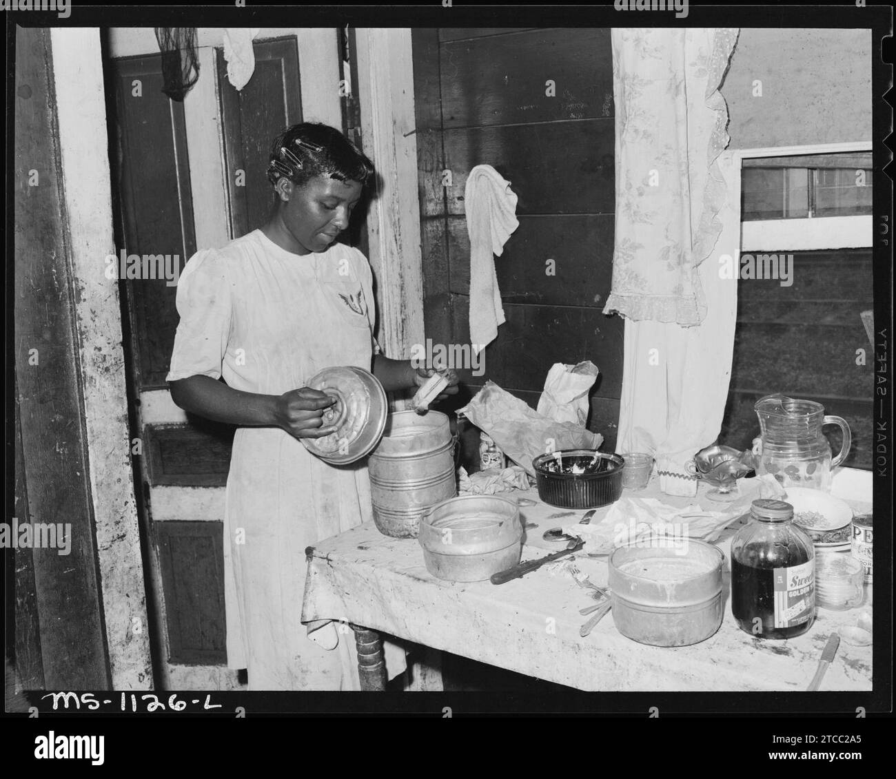 Wife of miner filling lunch bucket. They live in company housing