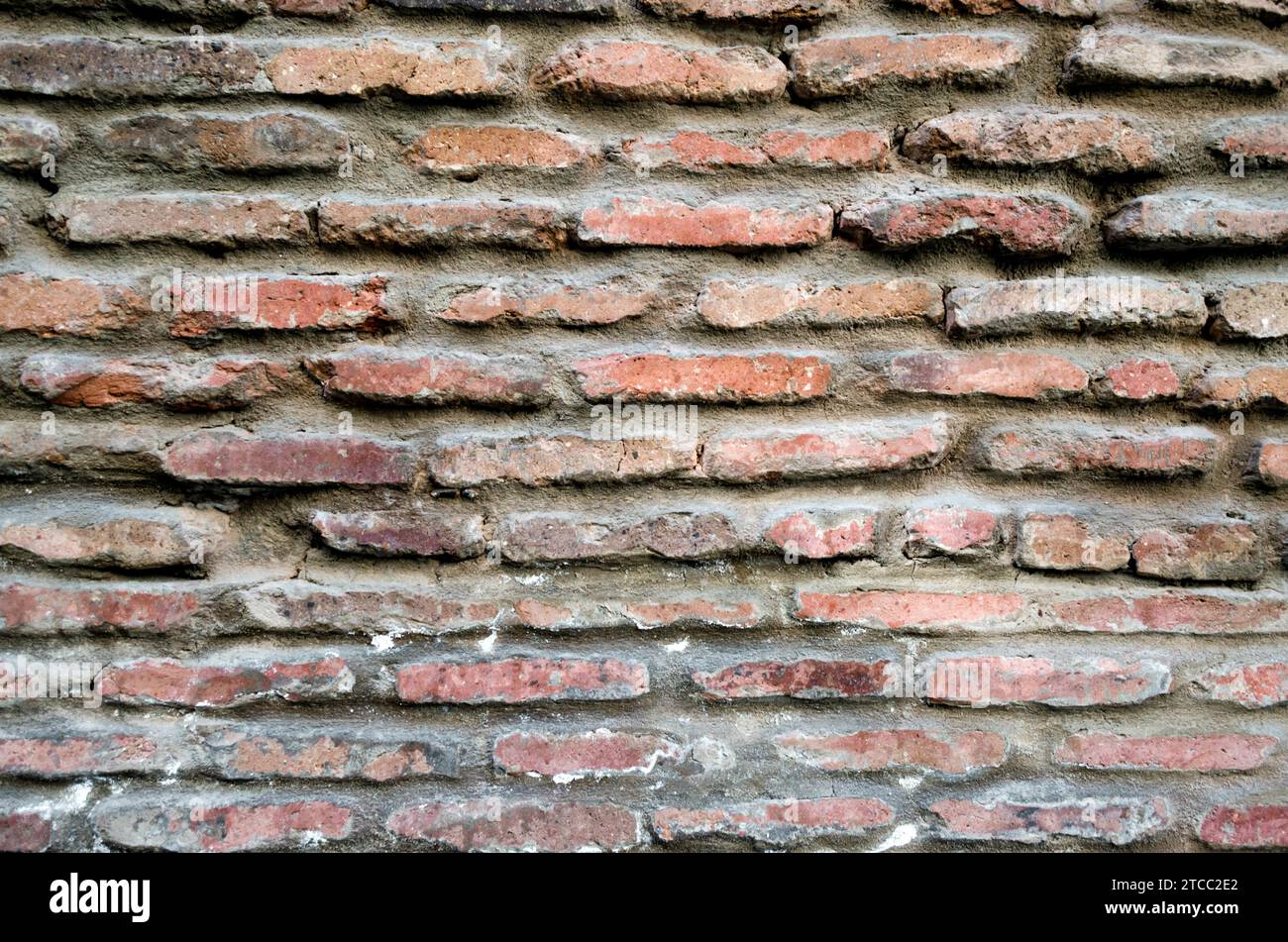 Pattern texture of old vintage orange brick wall detailed background close up Stock Photo