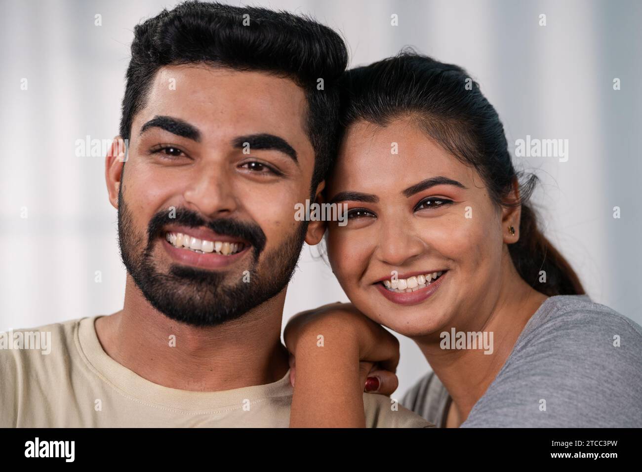 Close up shot of happy smiling indian couples embracing by looking ...
