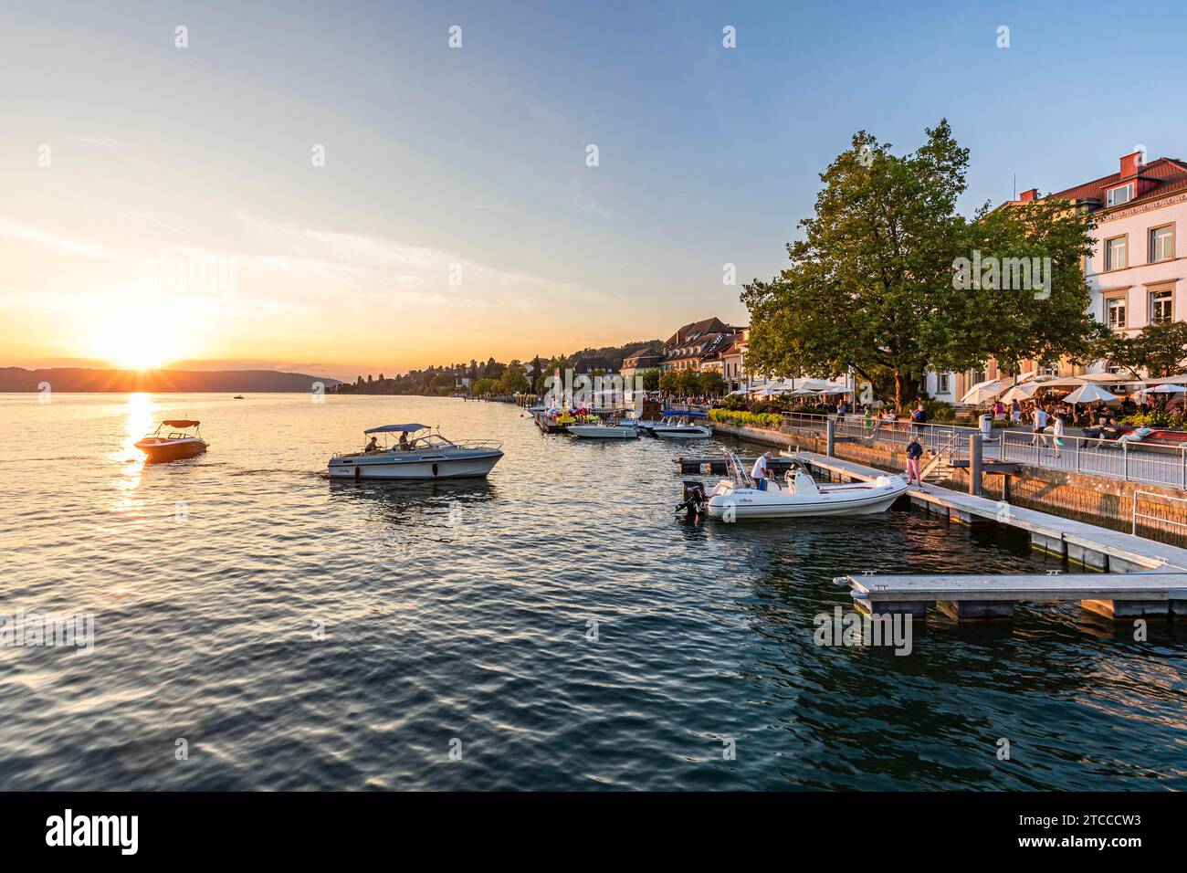 Motorboats and restaurants on the lakeside promenade in Ueberlingen, Lake Constance, Baden-Wuerttemberg, Germany Stock Photo