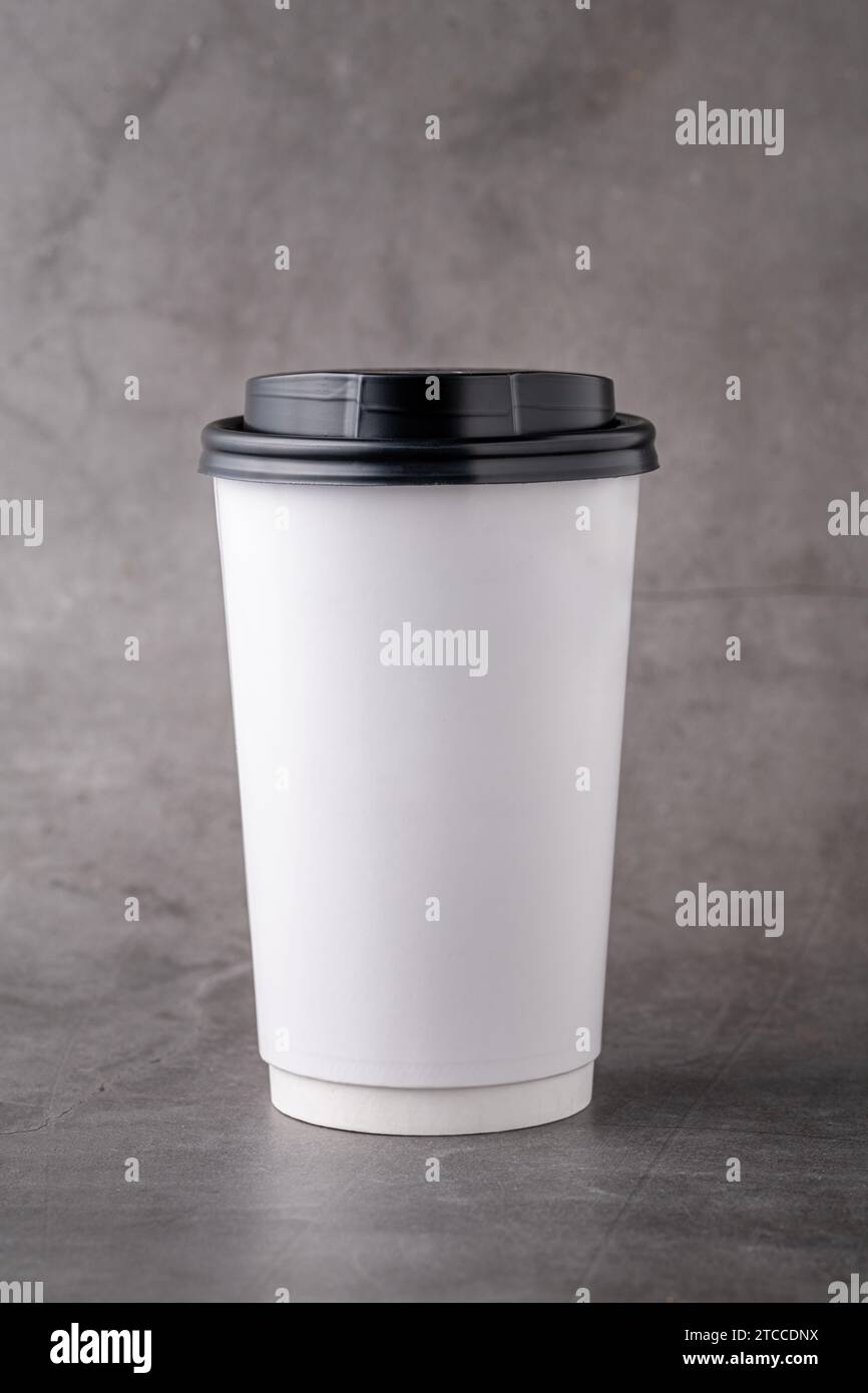 https://c8.alamy.com/comp/2TCCDNX/white-takeaway-paper-cup-with-black-plastic-lids-isolated-on-gray-background-2TCCDNX.jpg
