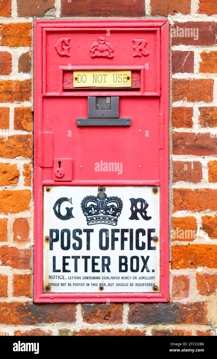 King George VI disused  red wall Post Office letter box, Great Glemham, Suffolk, England, UK - do not use Stock Photo