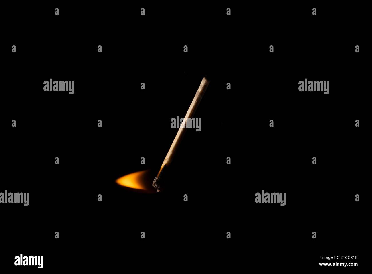 Lit and falling match on a black background. Stock Photo