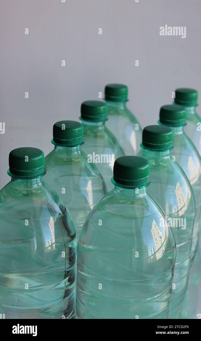 Rows of plastic bottles with clean water angled view studio isolated Stock Photo