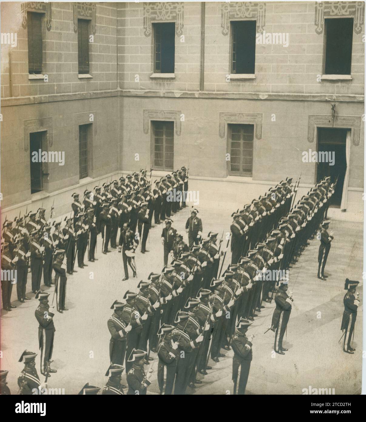 Madrid, June 1919. HM King Alfonso XIII reviewing the halberdier corps in a courtyard of the Royal Palace. Credit: Album / Archivo ABC Stock Photo