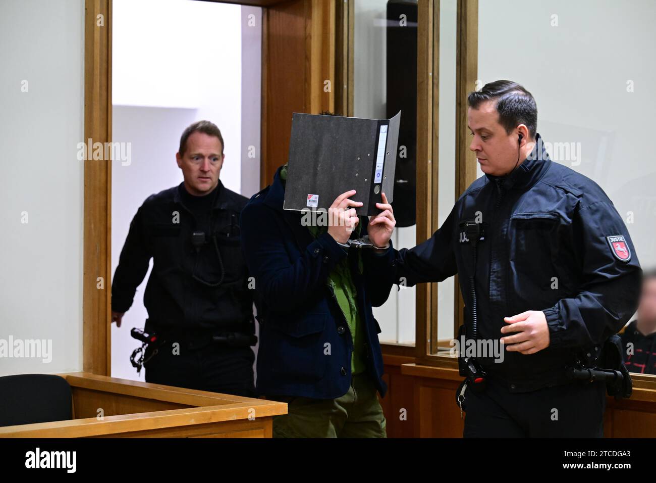 Oldenburg, Germany. 12th Dec, 2023. The accused is led into the