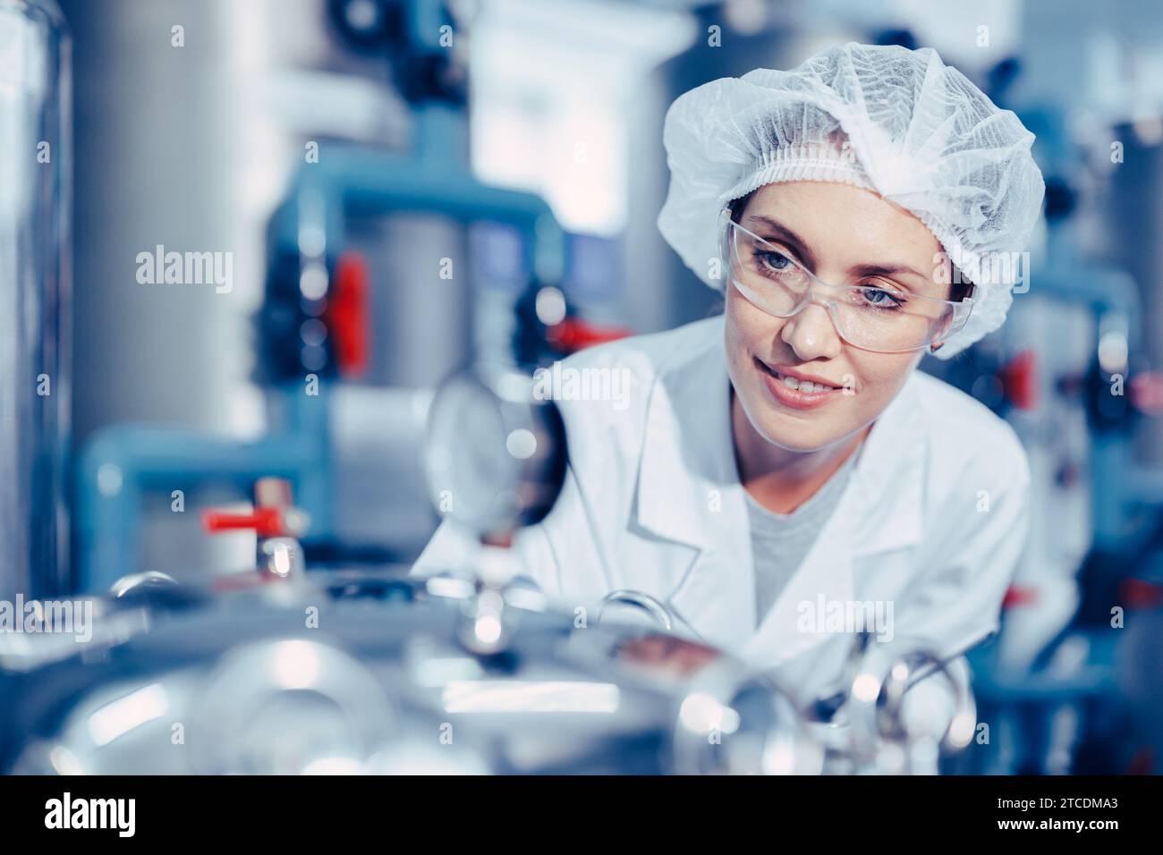 Women worker in drinking water plant clean hygiene uniform monitor