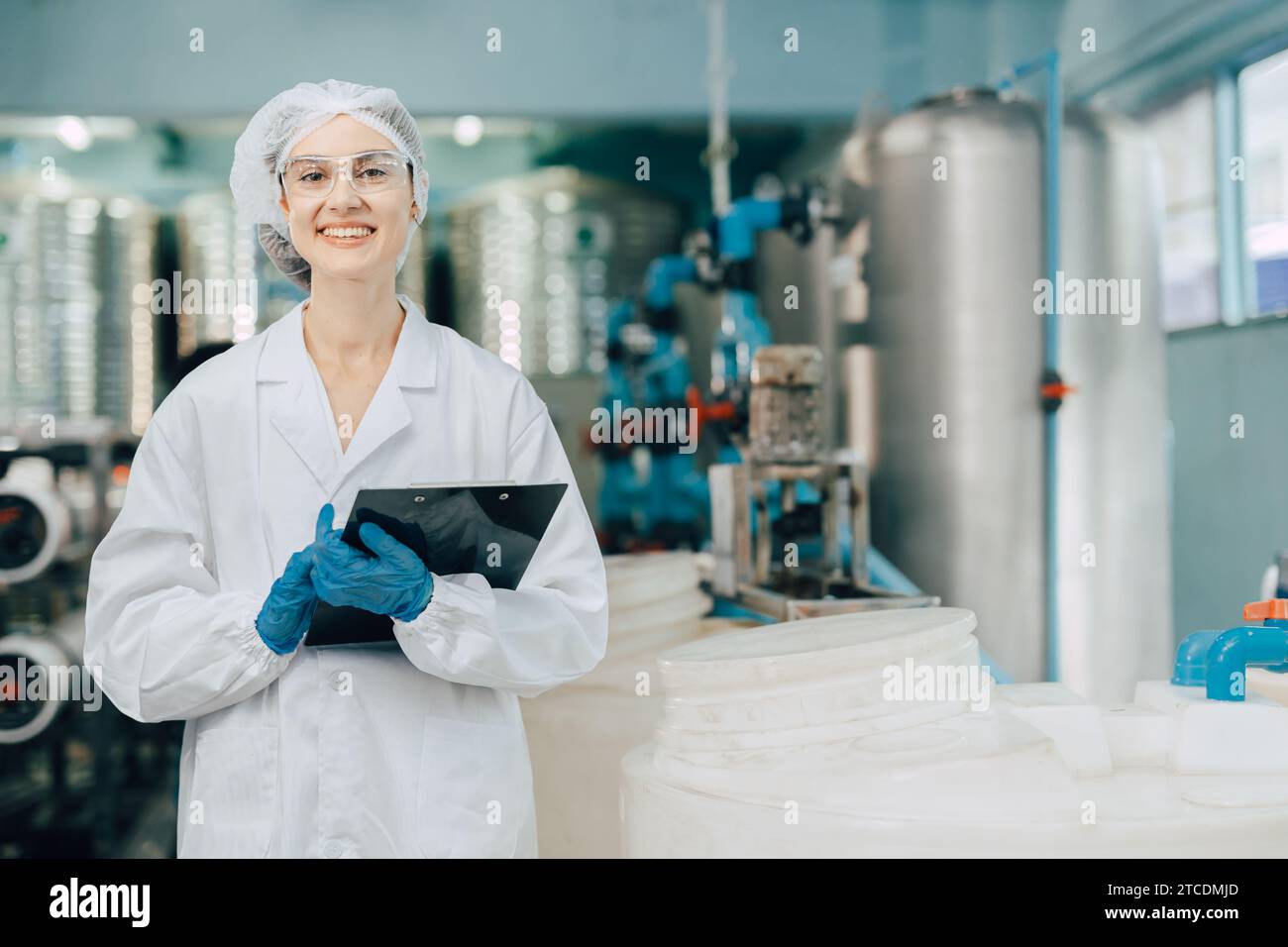 portrait happy women staff worker in drinking water plant work control water quality purification test process. Stock Photo