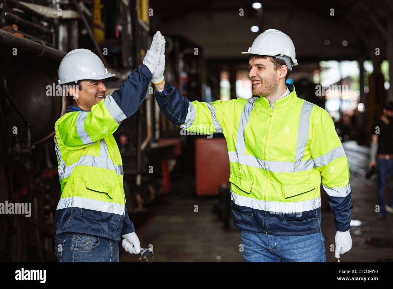 Worker happy greeting hi five hand gesture join friend meeting together. Jobs finished done well working industry teamwork. Stock Photo