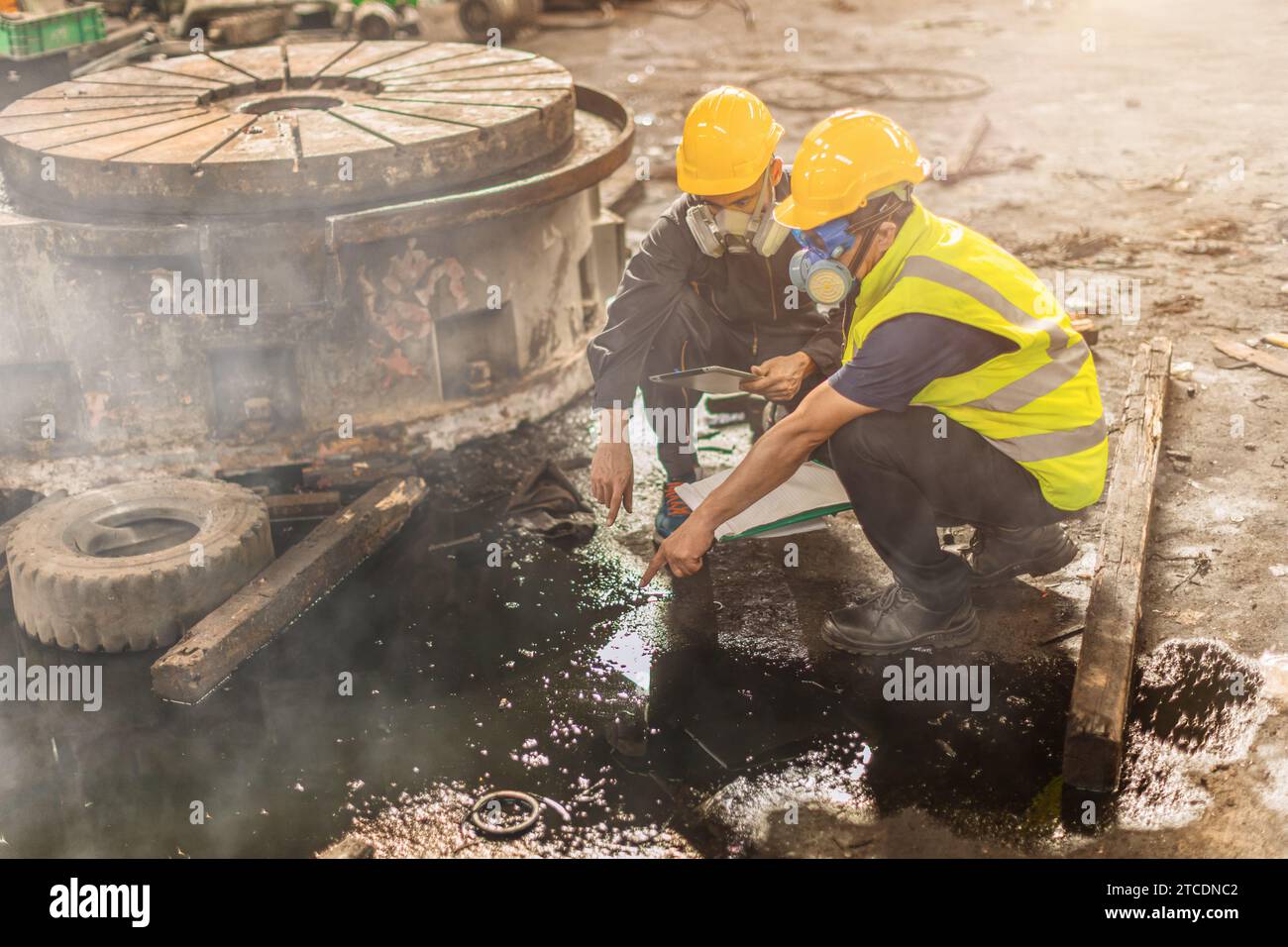 Chemical toxic liquid oil gas leak danger to environment impacts investigation team working site rescue and examination with safety Stock Photo