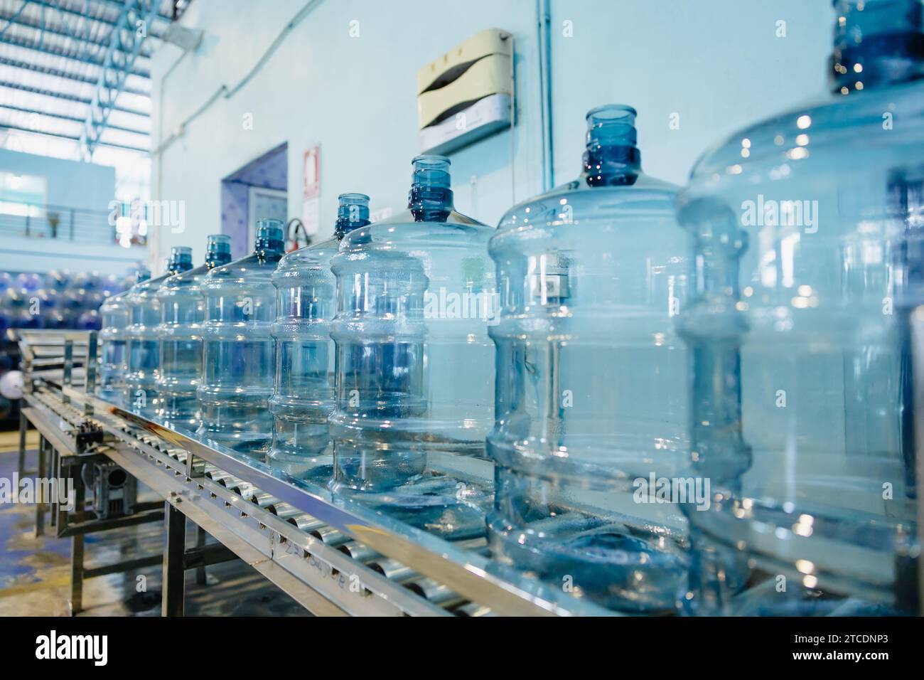 https://c8.alamy.com/comp/2TCDNP3/plastic-pet-drinking-water-gallon-bottle-clean-in-conveyor-production-line-in-drink-water-plant-factory-2TCDNP3.jpg