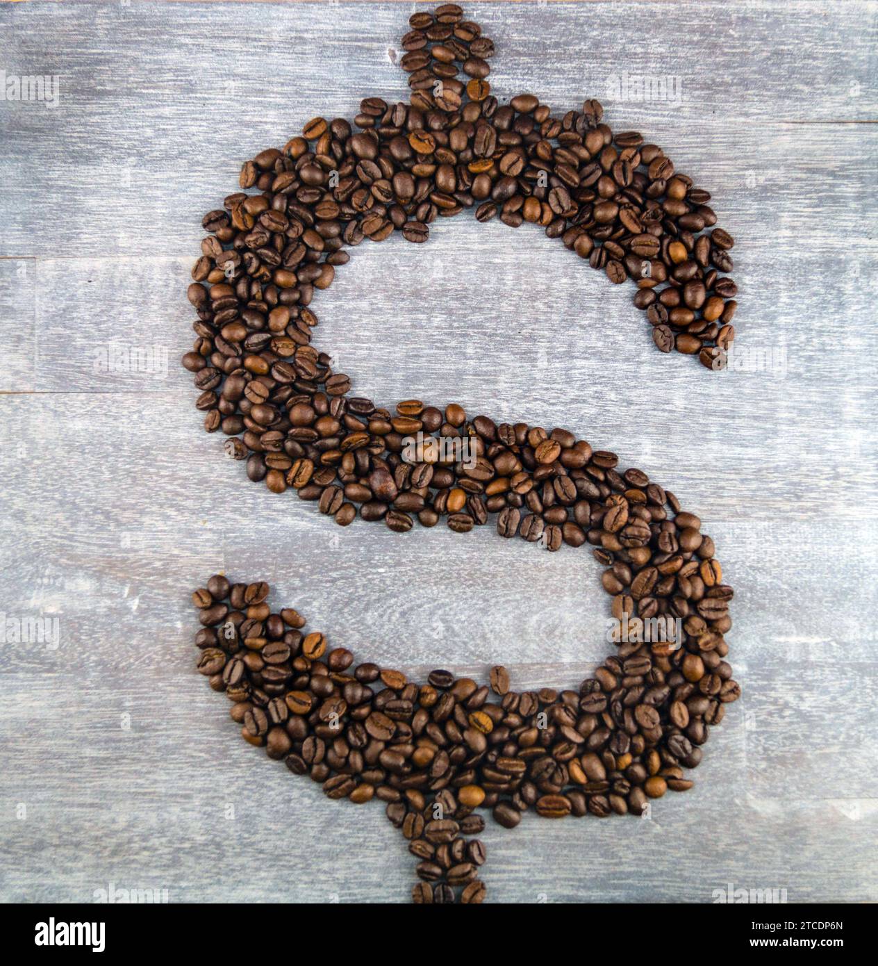 Dollar sign, formed with roasted coffee beans, coffee price Stock Photo