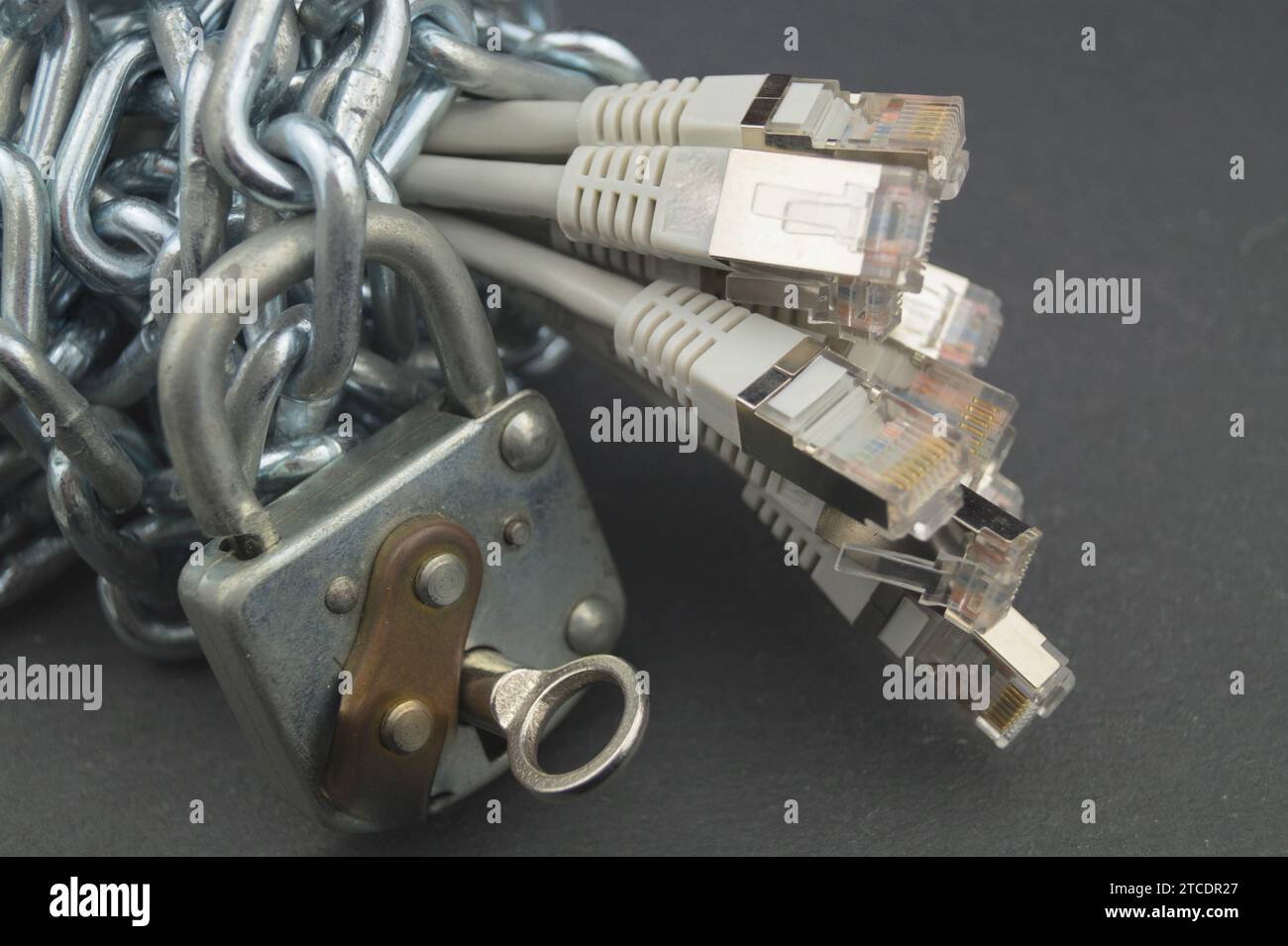 patch cables with chain and padlock, symbolic image for data protection