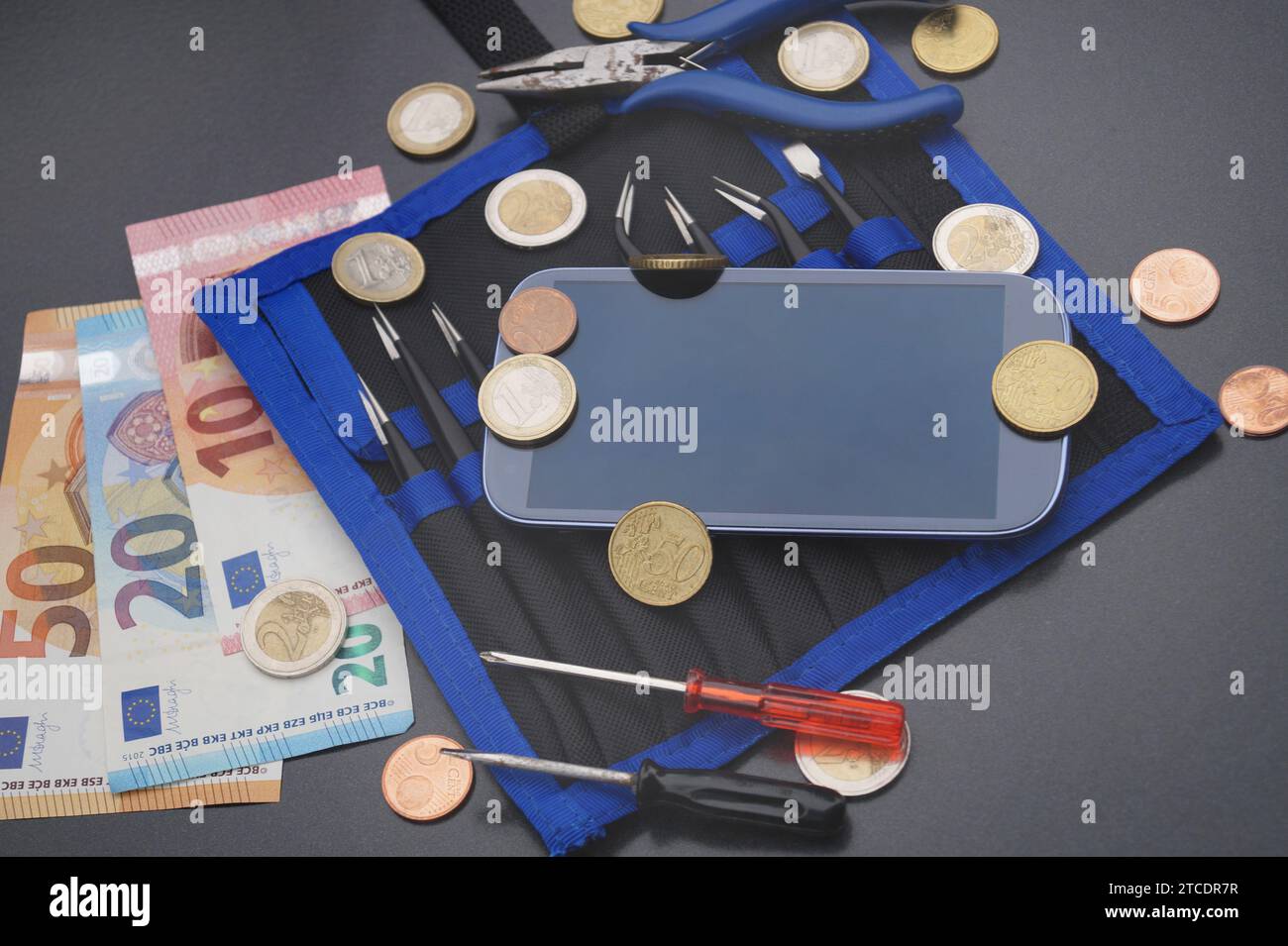 faulty mobile with Euros, and tools, symbol picture costs for mobile Stock Photo