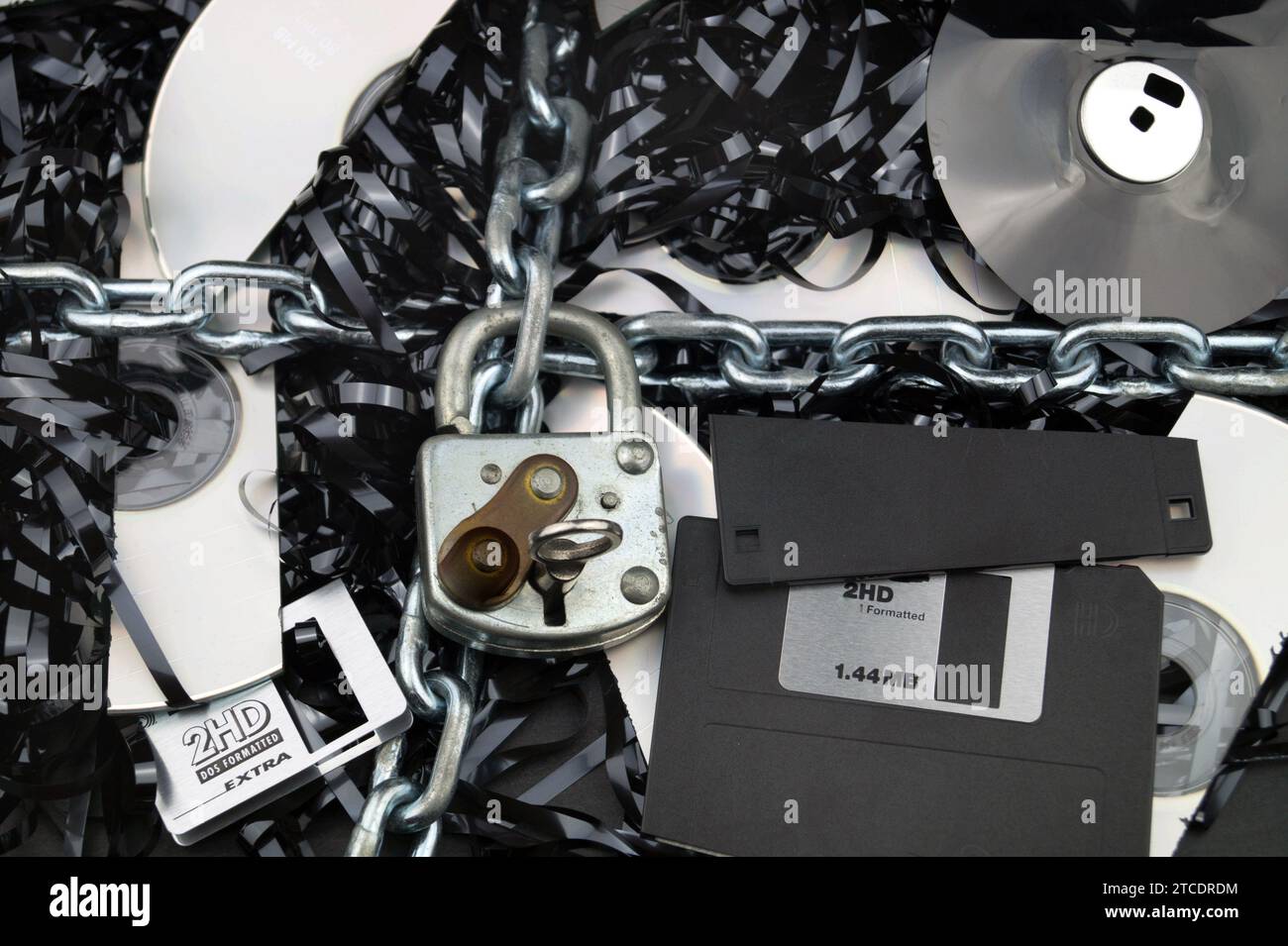 chain with padlock around destroyed data carriers, symbol for data ...