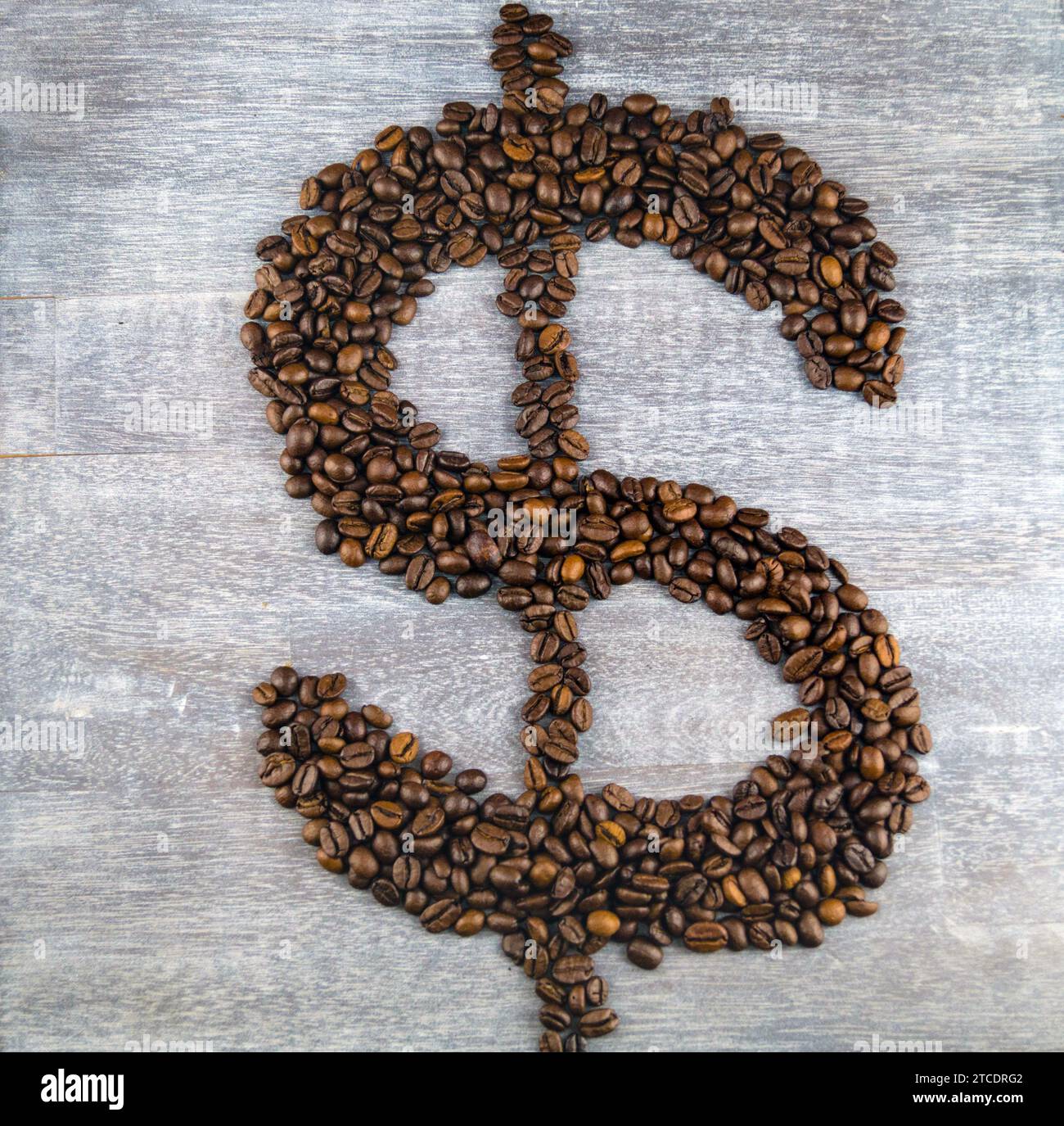 Dollar sign, formed with roasted coffee beans, coffee price Stock Photo