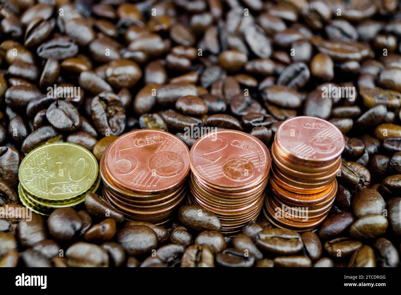coffee beans with piles of Euro coins, price increase of coffee Stock