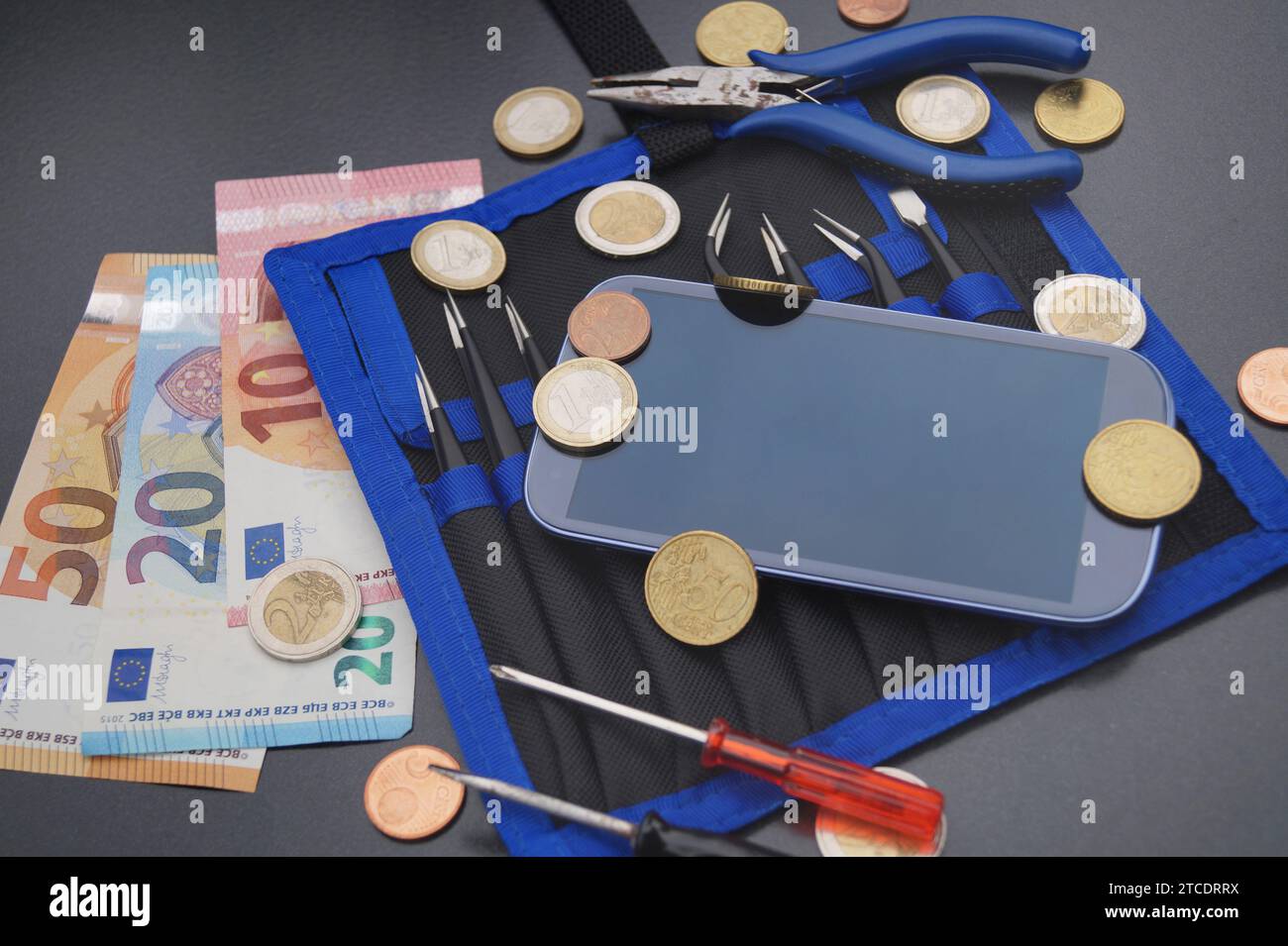 faulty mobile with Euros, and tools, symbol picture costs for mobile Stock Photo