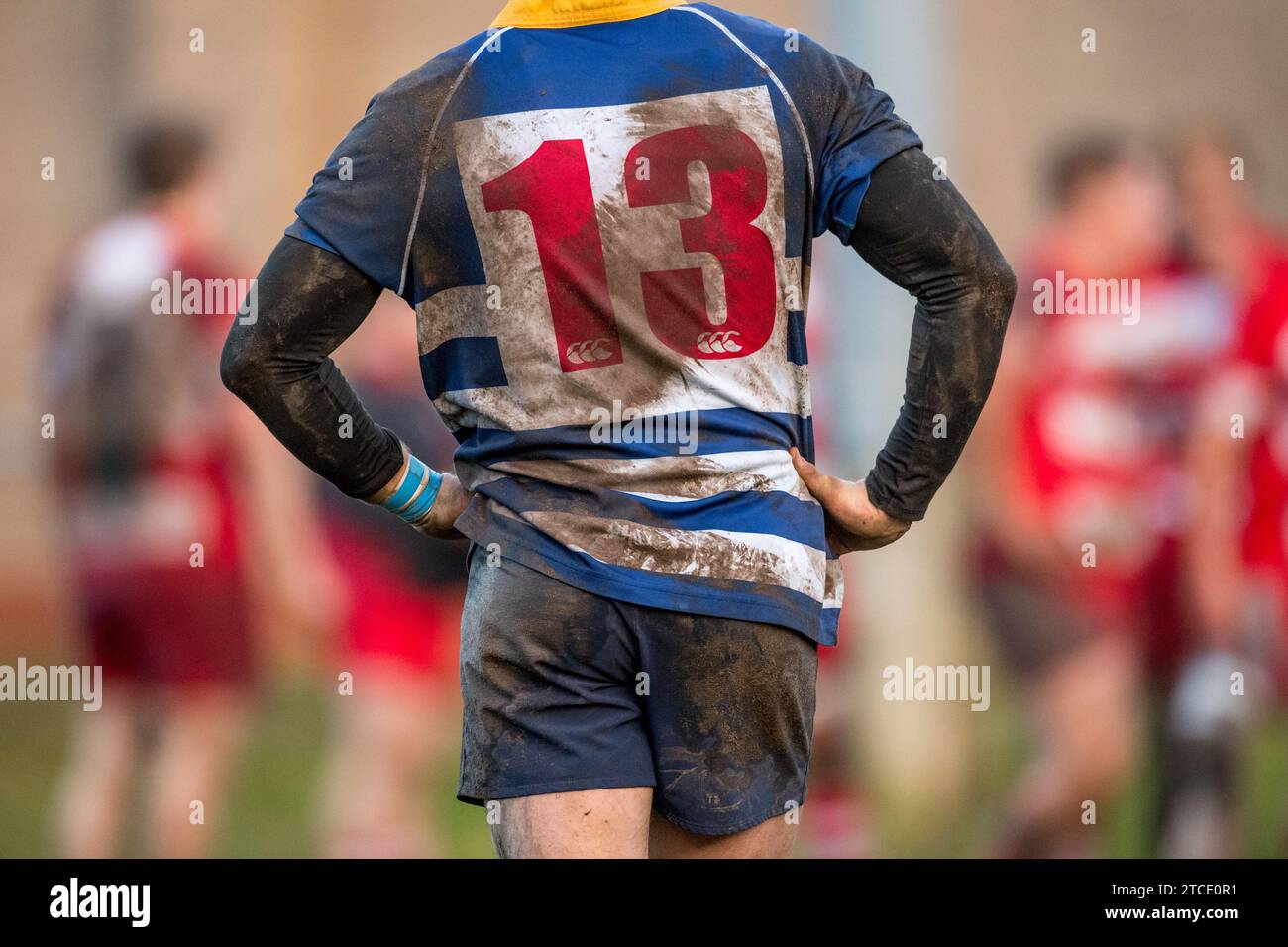 English amateur Rugby Union player with a dirty and muddy number 13 shirt. Stock Photo