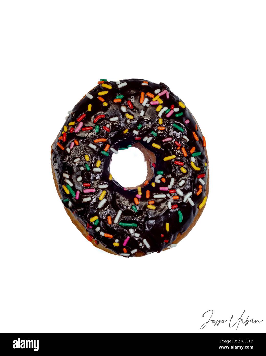 An appetizing chocolate donut with colorful sprinkles, freshly glazed and ready to be enjoyed Stock Photo
