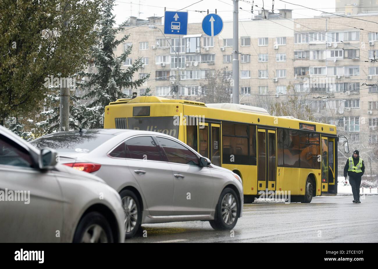 KYIV, UKRAINE - DECEMBER 11, 2023 - A police officer stands by a bus which runs between the closed metro stations of the Blue Line, Kyiv, capital of U Stock Photo