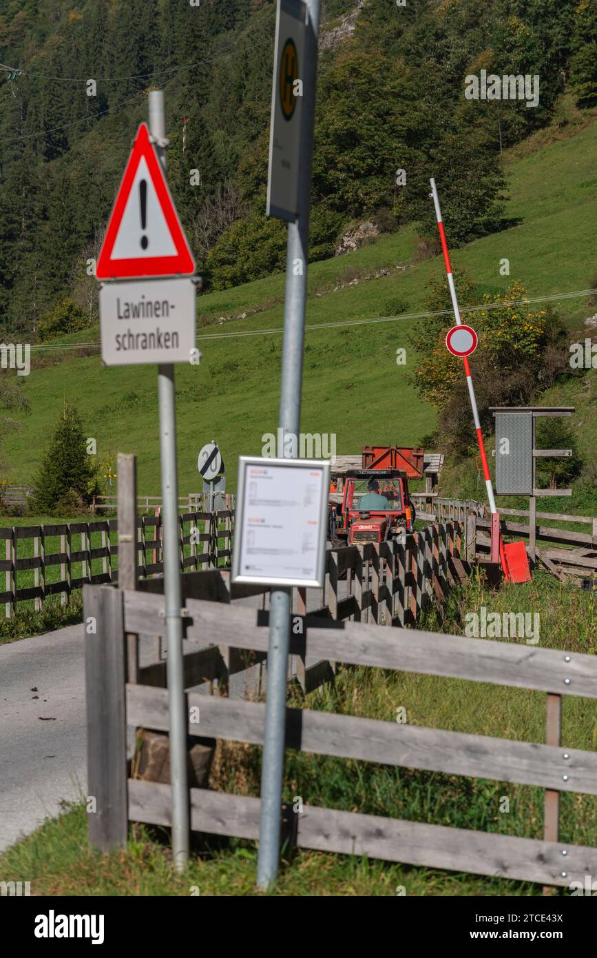 Road signs and barrier warning about avalanches in wintertime ...