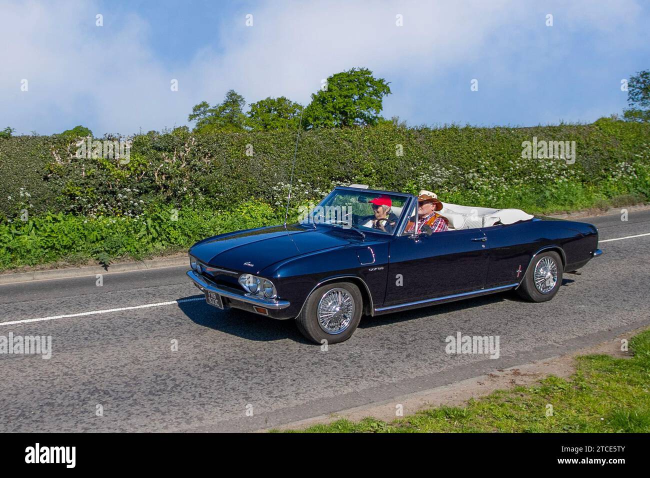 1965 60s sixties Black Chevrolet Corvair Chevy 2700cc petrol American convertible; Vintage, restored classic motors, automobile collectors motoring enthusiasts, historic veteran cars travelling in Cheshire, UK Stock Photo