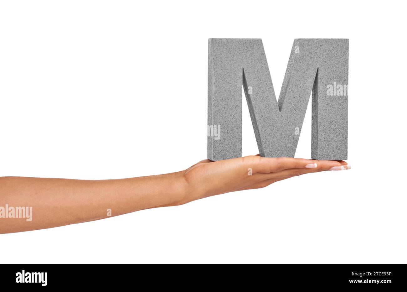 Woman, hand and letter M or font in studio for advertising, learning or teaching on mock up. Sign, alphabet or character for reading, text or Stock Photo