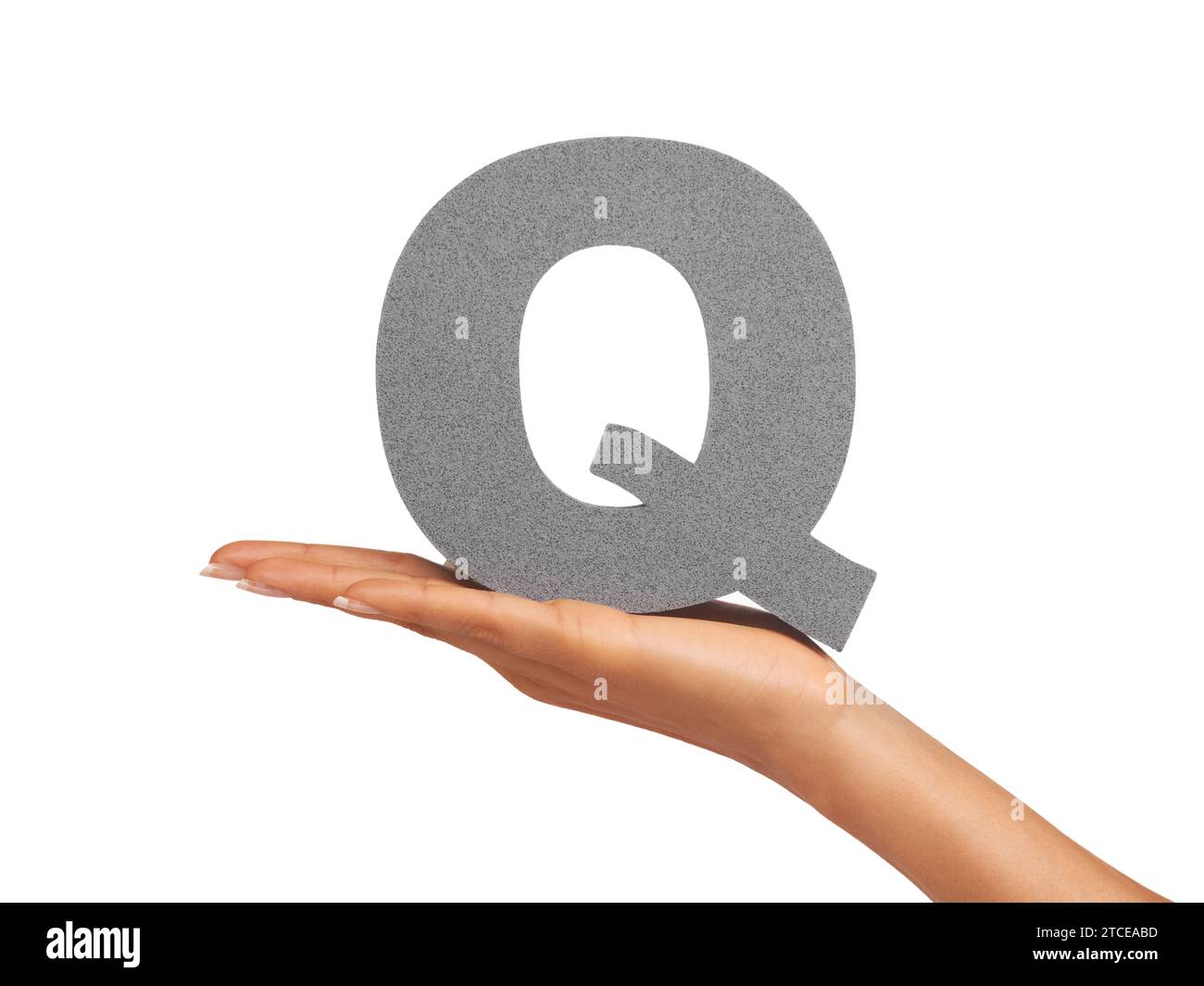 Woman, hand and letter Q or font in studio for advertising, learning or teaching presentation. Sign, alphabet or character for marketing, text or Stock Photo
